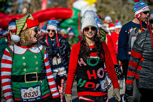 Natalie Hicks (left) and Stefanie Chambers participate in the Ugly Sweater Run at Piedmont Park in Atlanta on Saturday, December 19, 2015. 
