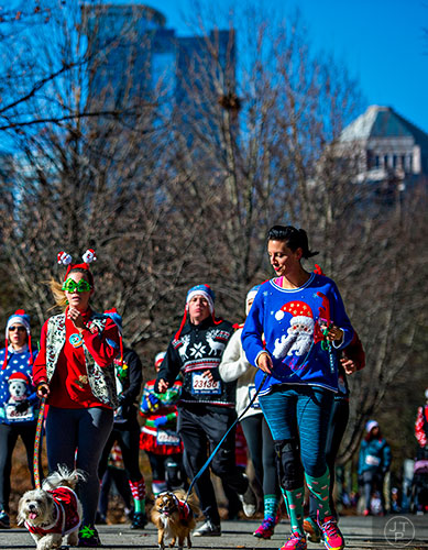 Danielle Dougherty (right) and Carrie Chappell participate in the Ugly Sweater Run at Piedmont Park in Atlanta on Saturday, December 19, 2015. 