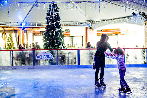 Maya Abboushi (left) skates with her daughter Nai at the Southwest Rink at Park Tavern in Atlanta on Saturday, December 26, 2015. 