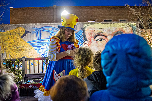 Twinkle Star the Clown makes balloon animals during the Chanukah celebration in Decatur Square on Thursday.