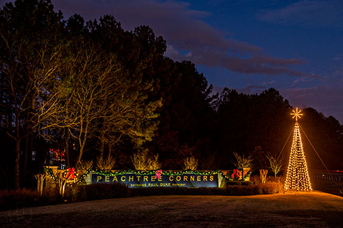 The Christmas tree lights up the gateway leading into the city of Peachtree Corners on Wednesday, November 25, 2015.