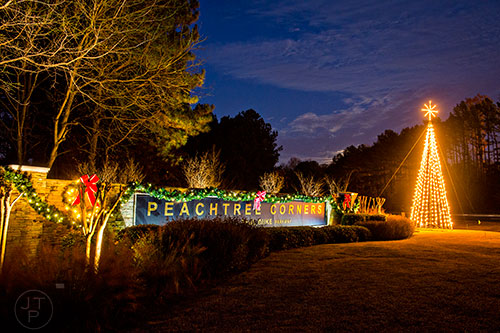 The Christmas tree lights up the gateway leading into the city of Peachtree Corners on Wednesday, November 25, 2015.
