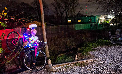 Pete Wicker climbs up the hill to Atlanta Beltline Bicycles as he gathers with around 50 other cyclists before the annual Atlanta Christmas Ride on Wednesday evening.