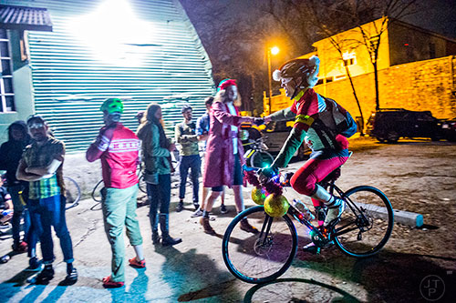 William Le Master (right) pulls up to Atlanta Beltline Bicycle with around 50 other cyclists before the annual Atlanta Christmas Ride on Wednesday evening.
