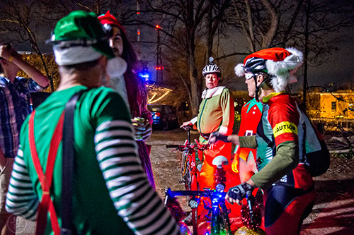 Dressed as an elf, Wes Lucas (center) gathers at Atlanta Beltline Bicycle with around 50 other cyclists before the annual Atlanta Christmas Ride on Wednesday evening.