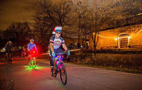 Pete Wicker rides down the Atlanta Beltline's Eastside Trail with around 50 other cyclists during the annual Atlanta Christmas Ride on Wednesday evening.