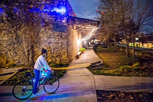 A cyclist takes off from Atlanta Beltline Bicycle to catch up with around 50 others as they participate in the annual Atlanta Christmas Ride on Wednesday evening.