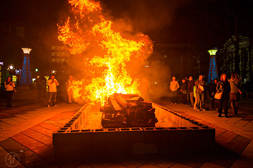 The large bonfire starts to burn at the start of the annual marshmallow roast at Decatur Square on Thursday.