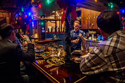 Grabbing a drink at the bar at Ticonderoga Club inside Krog St. Market on Friday.