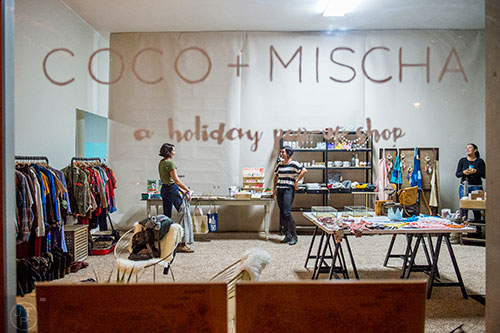 Elise Hitron (left) talks with Melissa Gallagher and Christy Hussain inside the Coco & Mischa holiday pop up shop off of Clairemont Ave. in Decatur on Thursday.