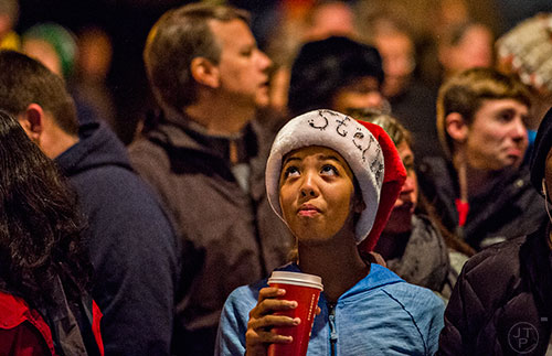 Stella Esposito-Gooden glances towards the Christmas tree in downtown Decatur during the annual lighting of the tree celebration on Thursday.