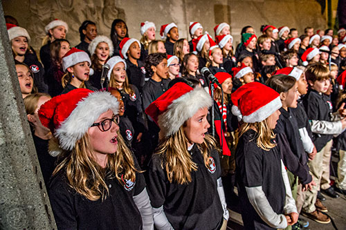Kathleen O'Shea (left) and Madelyn McElroy perform with the 4/5 Academy chorus during the annual tree lighting in downtown Decatur on Thursday.