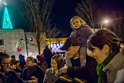 Amelia Gieraltowski sits on her father Matt's shoulders after the lighting of the tree in downtown Decatur on Thursday.