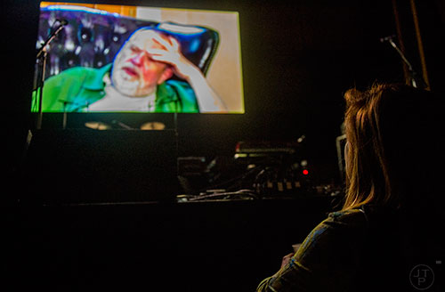 Robin Steinbrenner (right) watches a video of Alex Cooley during a tribute to the late music promoter at the Tabernacle in Atlanta on Saturday, January 9, 2016. 