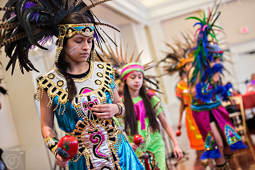 Ana Avilez (left) performs a traditional Aztec dance during the Dia de los Reyes, or Three Kings Day, celebration at the Atlanta History Center on Sunday, January 10, 2016.  