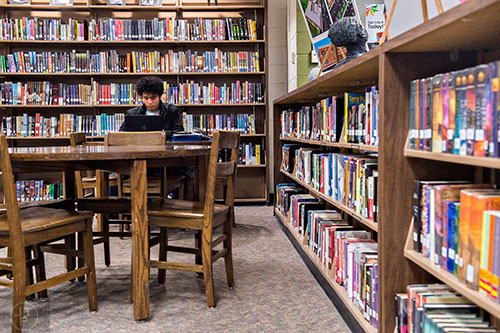 Aman Folami Reese (left) studies in the antiquated media center at Riverwood High School in Atlanta on Tuesday, January 12, 2016.