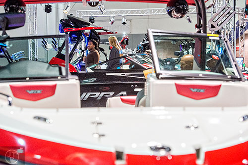 Taylor Wolfe (right) shows Nickeol Bills the features of a Supra SG550 during the 54th annual Atlanta Boat Show at the Georgia World Congress Center in Atlanta on Saturday, January 16, 2016. 