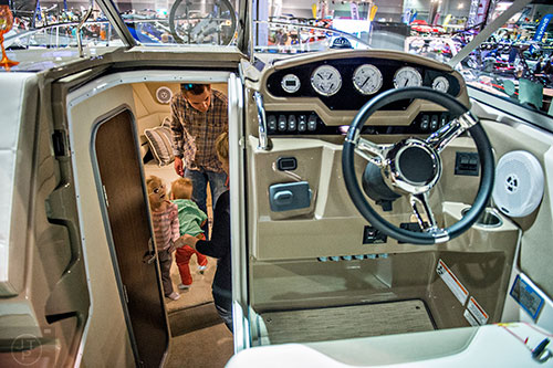 Harper Anderson (left) and her father Grant check out the cabin of a Regal 26 Express during the 54th annual Atlanta Boat Show at the Georgia World Congress Center in Atlanta on Saturday, January 16, 2016. 