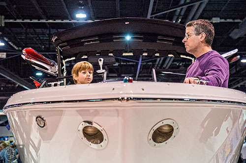 Bryce File (left) and his father Jay sit in the bow of a Cobalt R5 WSS during the 54th annual Atlanta Boat Show at the Georgia World Congress Center in Atlanta on Saturday, January 16, 2016. 