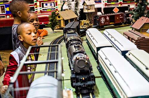 Judah Thomas (left) and his brothers Jonathan and Joseph watch trains pass by in a display during the 50th annual Atlanta Model Train And Railroadiana Show And Sale at the North Atlanta Trade Center in Norcross on Saturday, January 16, 2016. 