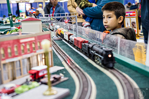 Wyatt Boudway (right) watches a train pass by during the 50th annual Atlanta Model Train And Railroadiana Show And Sale at the North Atlanta Trade Center in Norcross on Saturday, January 16, 2016. 