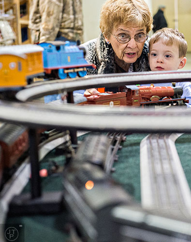 Martha Zimmer (left) holds her grandson Hughie White as he operates a model train during the 50th annual Atlanta Model Train And Railroadiana Show And Sale at the North Atlanta Trade Center in Norcross on Saturday, January 16, 2016. 