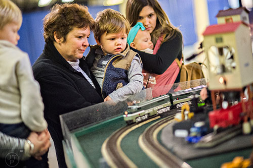 Maria McClung (left) holds her grandson Liam Ward as they watch a train pass by during the 50th annual Atlanta Model Train And Railroadiana Show And Sale at the North Atlanta Trade Center in Norcross on Saturday, January 16, 2016. 