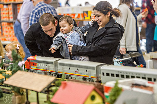 Patrick McGaughey (center) points out a passing train to his father Marshall and mother Josseline during the 50th annual Atlanta Model Train And Railroadiana Show And Sale at the North Atlanta Trade Center in Norcross on Saturday, January 16, 2016.