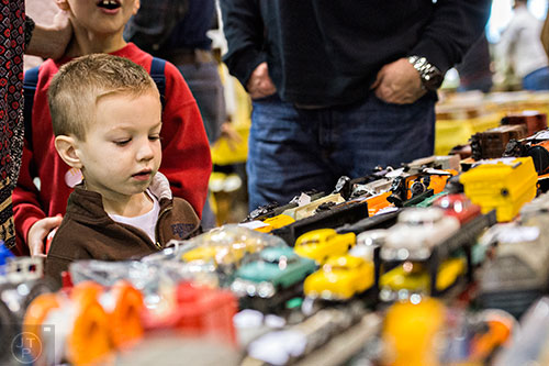 Riley Curnutt looks at different train cars for sale during the  50th annual Atlanta Model Train And Railroadiana Show And Sale at the North Atlanta Trade Center in Norcross on Saturday, January 16, 2016. 