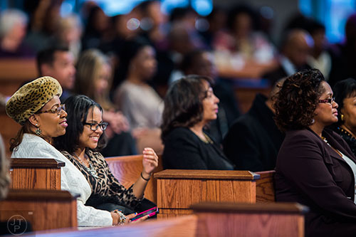Beverly James (left) and her daughter Brianna Ellis James wait for the start of the 48th Martin Luther King Jr. Annual Commemorative Service at Ebenezer Baptist Church in Atlanta on Monday, January 18, 2016. 