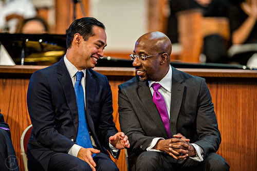 Julian Castro (left), the United States Secretary for the Department of Housing and Urban Development, speaks to Rev. Raphael Gamaliel Warnock during the 48th Martin Luther King Jr. Annual Commemorative Service at Ebenezer Baptist Church in Atlanta on Monday, January 18, 2016. 