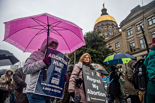 Julie Thomas (left), Jody Duffy and a couple hundred pro life supporters leave Liberty Plaza across from the state capitol building in Atlanta as they start the Georgia March for Life on Friday, January 22, 2016. 