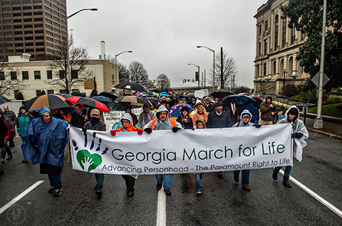 A couple hundred pro life supporters walk down Martin Luther King Jr. Dr. next to the state capitol building in Atlanta during the Georgia March for Life on Friday, January 22, 2016. 