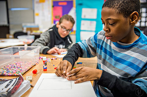Joshua Orji (right) and Jadan Rodriguez work on an assignment in their fifth grade advanced math class at Centerville Elementary School in Snellville on Friday, January 22, 2016. 