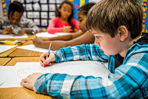 Fourth grader Alex Clark (right) works on an assignment in class at Centerville Elementary School in Snellville on Friday, January 22, 2016. 