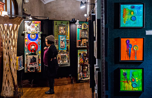 Kristi Jeans (center) looks at the different artwork on display during the Callanwolde Arts Festival in Atlanta on Saturday, January 23, 2016. 