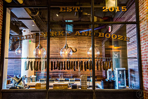 Authentic South African jerky can be seen hanging in the window at Biltong Bar inside Ponce City Market in Atlanta.
