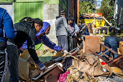 Portia Langley (left) and Ousman Sy clean up debris during the 14th annual Martin Luther King Jr. Service Project on Sunday.
