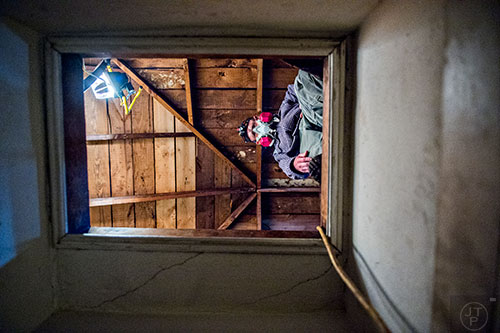 Frank Burdette works in the attic of a house off of S. McDonough St. in Decatur during the 14th annual Martin Luther King Jr. Service Project on Sunday.
