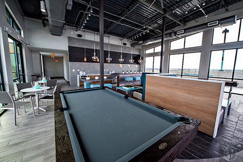 A pool table and shuffle board inside the rooftop lounge at The Brady off of Howell Mill Rd. on the west side of Atlanta.