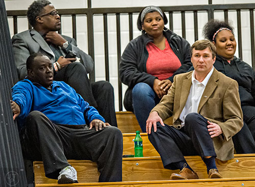 University of Georgia's new head coach Kirby Smart (right) talks to Derrick Brown's mother Martha, father James and UGA defensive line coach Tracy Rocker as they watch him play during the Lanier basketball game against Gainesville on Thursday, January 28, 2016. 
