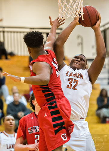 Lanier High School's Derrick Brown (left) tries to shoot for two past Gainesville's Farris Mance (left) on Thursday, January 28, 2016. 