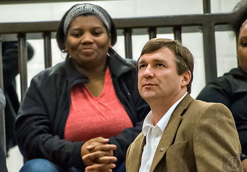 University of Georgia's new head coach Kirby Smart (right) talks to Derrick Brown's parents as they watch him play during the Lanier basketball game against Gainesville on Thursday, January 28, 2016. 