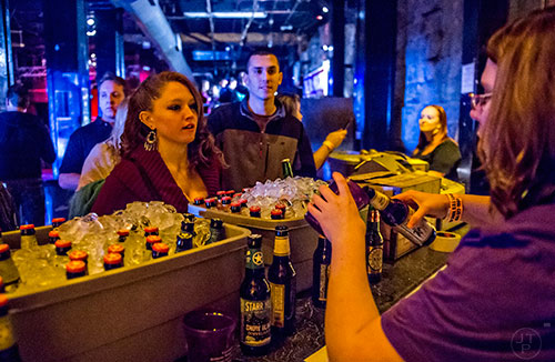 Stephanie Asay (left) and Sasha Fridman talk to Ashley Tippett as she pours their beers during the Atlanta Winter Beer Fest at The Masquerade in Atlanta on Saturday, January 30, 2016. 