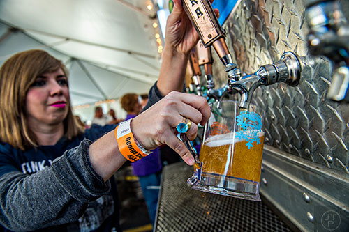 Amber Jaric (left) pours beer into a glass during the Atlanta Winter Beer Fest at The Masquerade in Atlanta on Saturday, January 30, 2016.