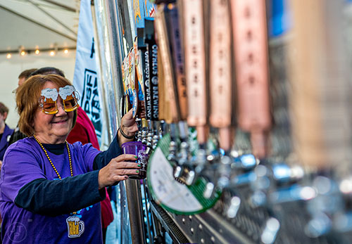Mercene Lee (left) pours beer into a glass during the Atlanta Winter Beer Fest at The Masquerade in Atlanta on Saturday, January 30, 2016. 