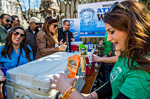Emily Lupoli (right) pours a Blue Moon beer during the Atlanta Winter Beer Fest at The Masquerade in Atlanta on Saturday, January 30, 2016. 