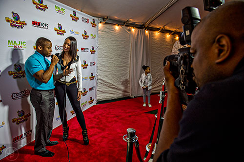 Sheyonna from "She's Got Game" (center) is interviewed by Darnell L. James as she walks the red carpet before the opening night of the UniverSoul Circus in Atlanta on Wednesday, February 3, 2016.  