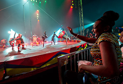 Ceaira Jackson (right) dances in her seat as the African Dream Team performs during the opening night of the UniverSoul Circus in Atlanta on Wednesday, February 3, 2016.