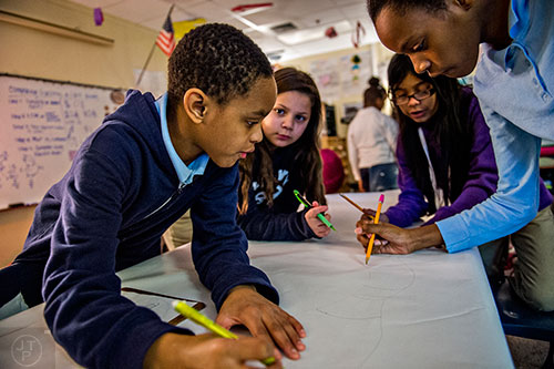 Antar Green (left), Brianna Espinoza, Kathleen Alfaro and Nia Murchison work together to draw a bug character during class at Powder Springs Elementary School in Powder Springs on Thursday, January 28, 2016. 